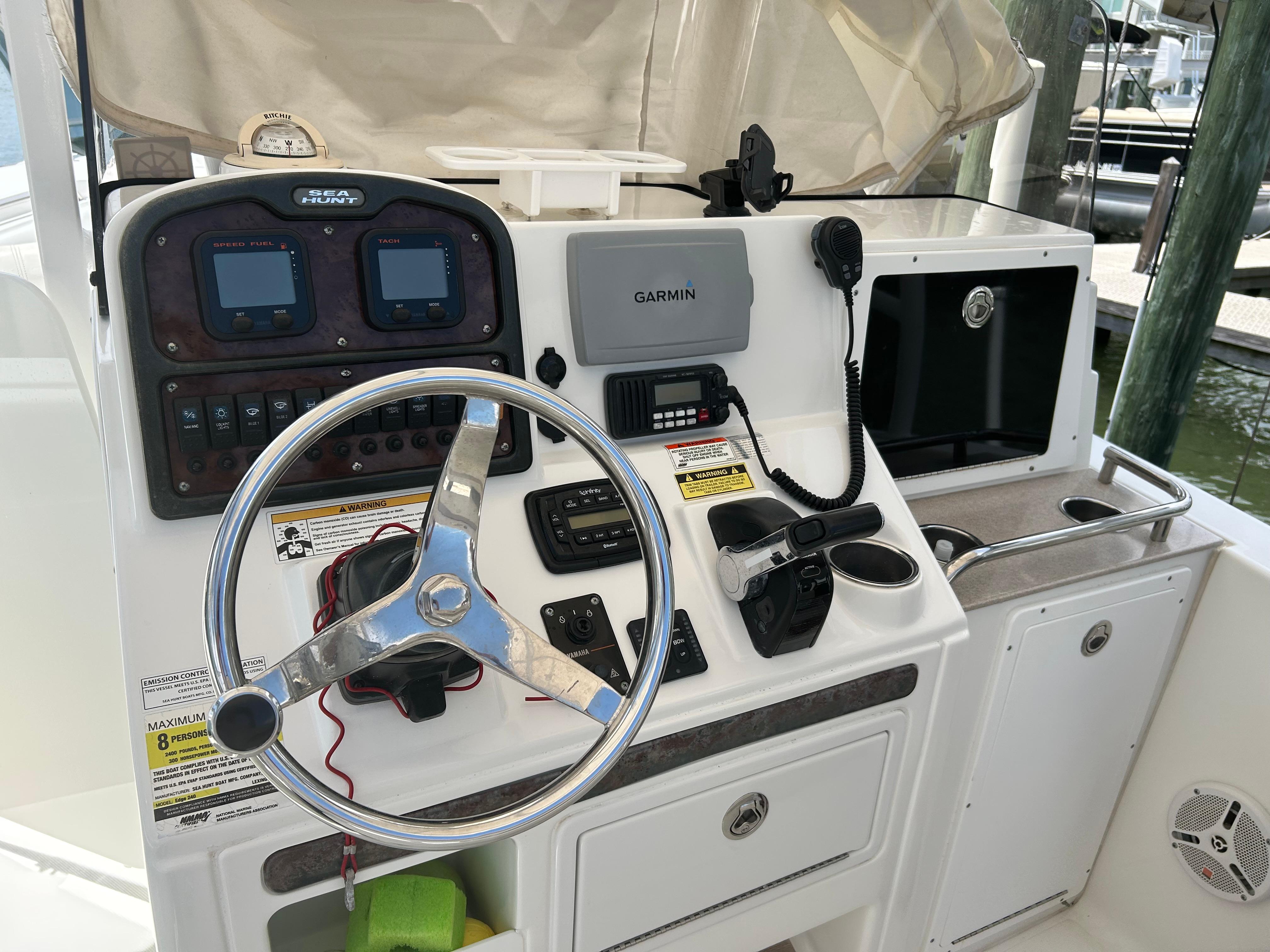 Slide: The Image of Control panel of a 2013 Sea Hunt Edge 24 boat with steering wheel and navigation equipment. - 10