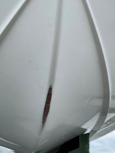 Slide: The Image of Close-up of a 2015 Sea Hunt Edge 24 boat hull with visible damage. - 12