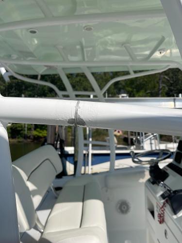 Slide: The Image of 2015 Sea Hunt Edge 24 boat interior with damaged railing. - 18