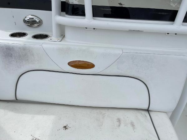 Slide: The Image of 2015 Sea Hunt Edge 24 boat interior with white seating and cup holders. - 8