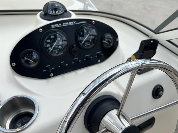 Slide: The Image of Steering console of a 2000 Sea Hunt Escape 200 boat with gauges and compass. - 10