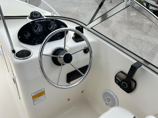Slide: The Image of Steering console of a 2000 Sea Hunt Escape 200 boat with gauges and controls. - 11