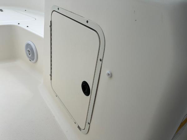 Slide: The Image of Sea Hunt Escape 200 boat storage compartment, 2000 model, with speaker and white interior. - 12