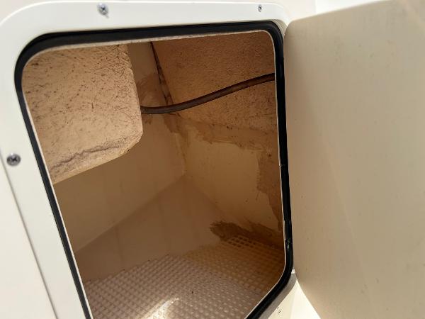 Slide: The Image of Open storage compartment on a 2000 Sea Hunt Escape 200 boat. - 15
