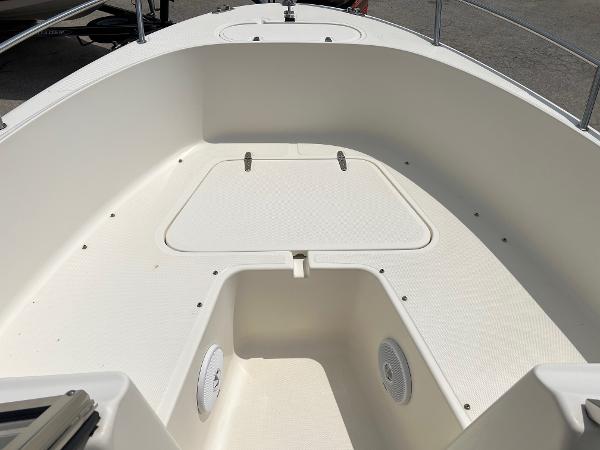 Slide: The Image of 2000 Sea Hunt Escape 200 boat interior, featuring a spacious, clean deck with storage compartment. - 16