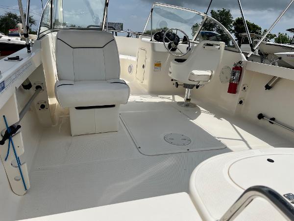 Slide: The Image of 2000 Sea Hunt Escape 200 boat interior with seating and steering wheel. - 2