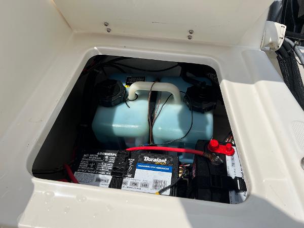 Slide: The Image of Battery compartment of a 2000 Sea Hunt Escape 200 boat, featuring a Duralast marine battery. - 21