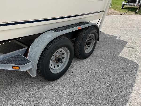 Slide: The Image of Trailer wheels of a 2000 Sea Hunt Escape 200 boat on pavement. - 3