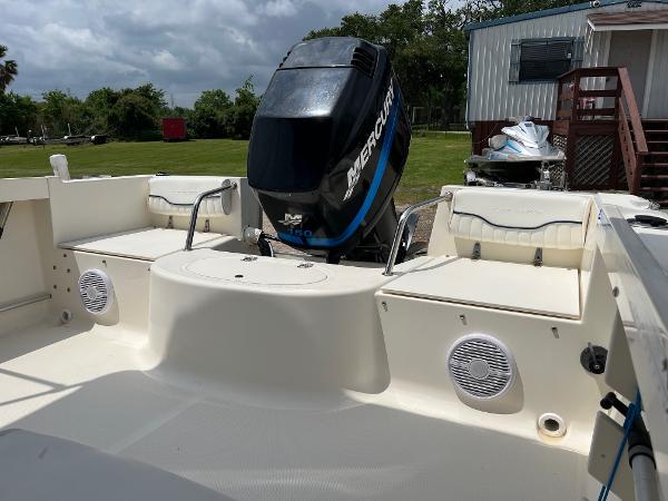 Slide: The Image of 2000 Sea Hunt Escape 200 boat with Mercury outboard motor, parked outdoors. - 4