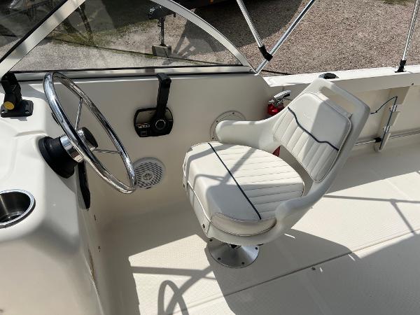 Slide: The Image of Captain's seat and steering wheel of a 2000 Sea Hunt Escape 200 boat. - 6