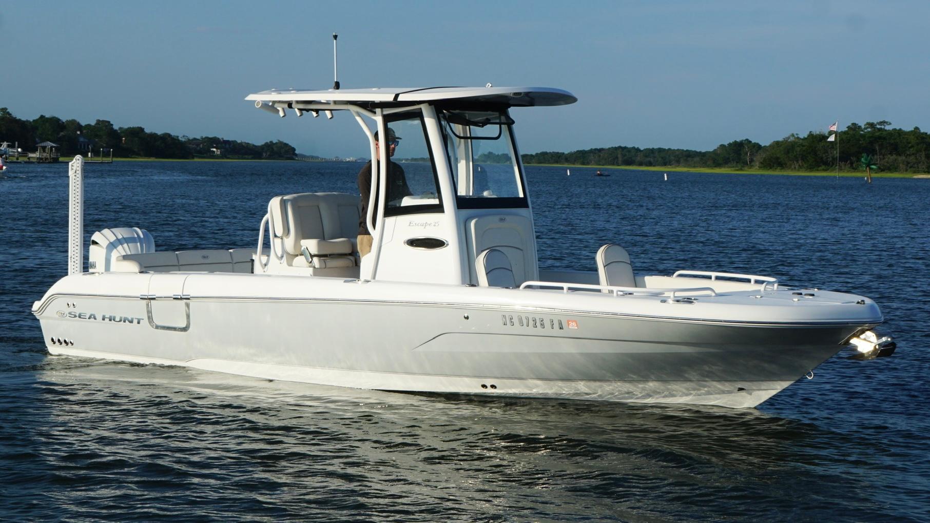 Slide: The Image of 2023 Sea Hunt Escape 25 boat cruising on a calm lake. - 1