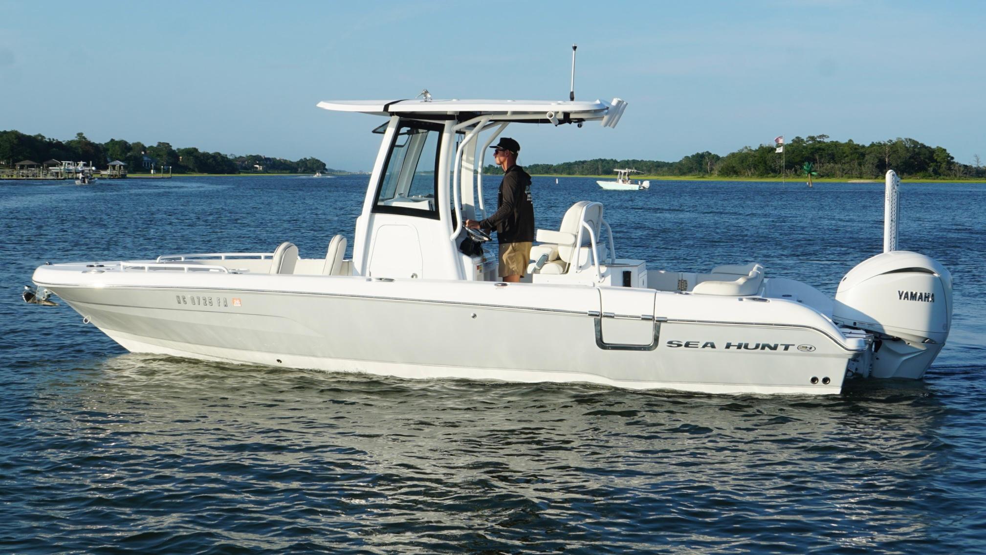 Slide: The Image of 2023 Sea Hunt Escape 25 boat on water with Yamaha engine. - 6