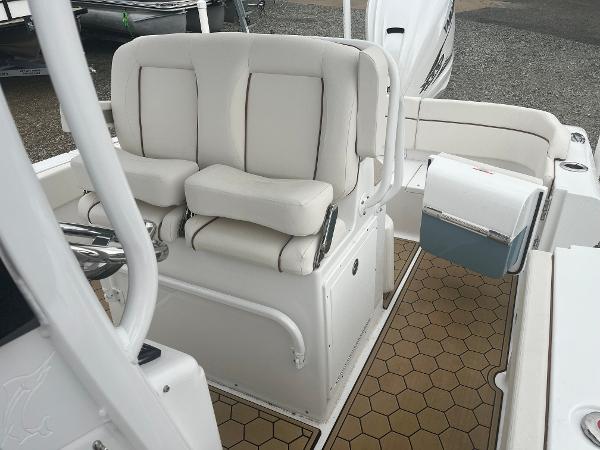 Slide: The Image of 2022 Sea Hunt Escape 27 boat interior with cushioned seating and storage. - 10