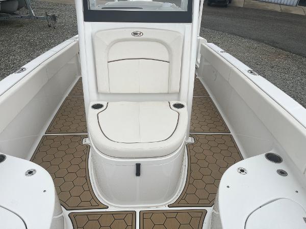 Slide: The Image of 2022 Sea Hunt Escape 27 boat interior with white seating and hexagonal floor design. - 11