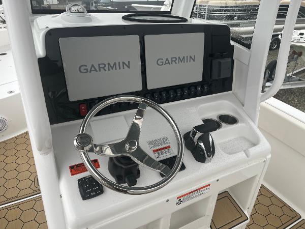 Slide: The Image of 2022 Sea Hunt Escape 27 helm with dual Garmin displays and stainless steel steering wheel. - 4