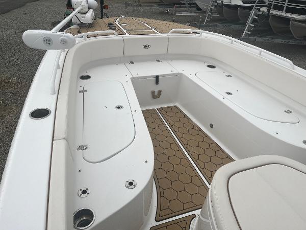 Slide: The Image of 2022 Sea Hunt Escape 27 boat interior with white seating and hexagonal floor design. - 6
