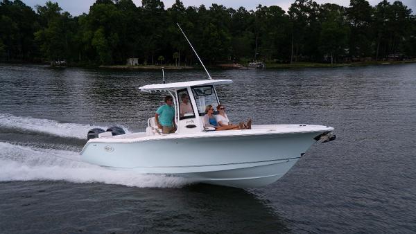 Slide: The Image of 2025 Sea Hunt Gamefish 27 Coffin Box cruising on a lake with passengers. - 0