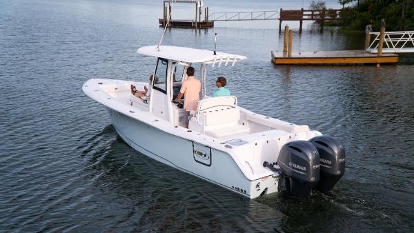 Slide: The Image of 2025 Sea Hunt Gamefish 27 Coffin Box boat on water with dual Yamaha engines. - 21