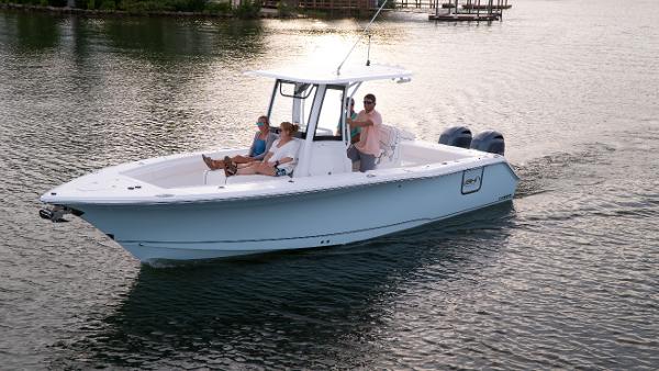 Slide: The Image of 2025 Sea Hunt Gamefish 27 Coffin Box boat cruising on a calm lake. - 22