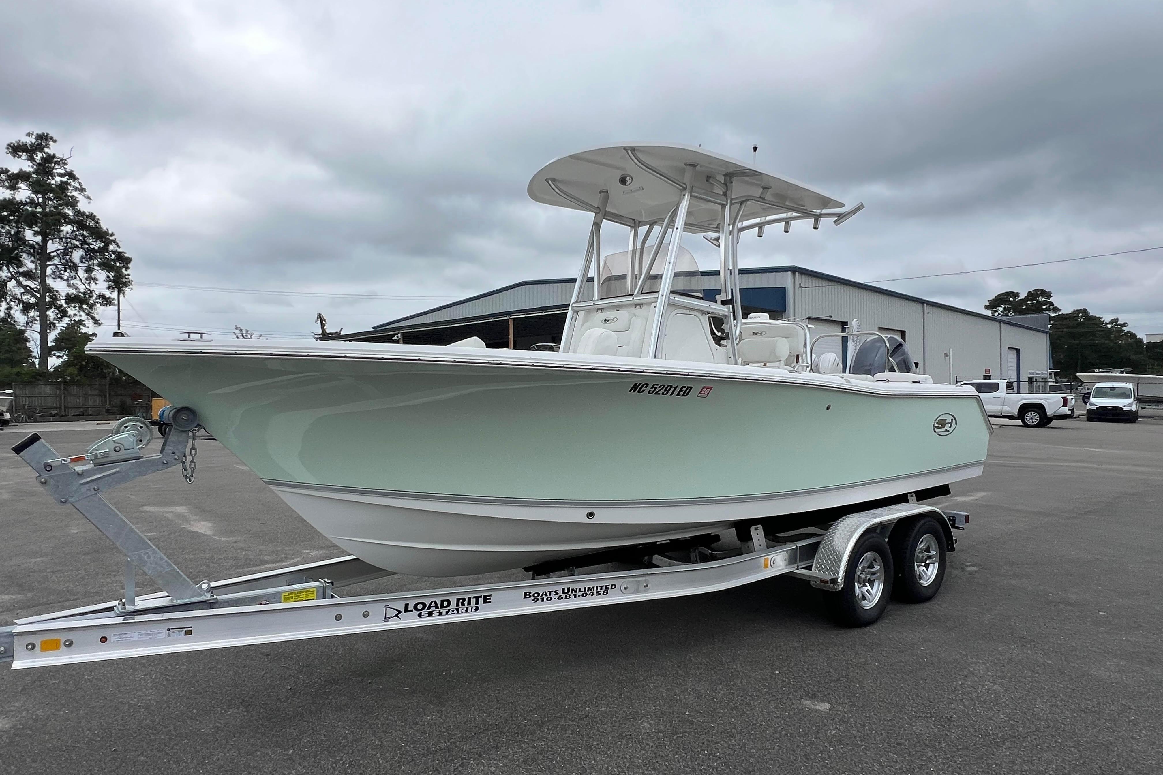 Slide: The Image of 2016 Sea Hunt Ultra 225 boat on trailer in parking lot, overcast sky. - 5