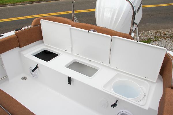 Slide: The Image of 2024 Sea Hunt Ultra 234 boat storage compartments and seating area. - 12