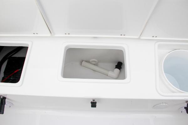 Slide: The Image of 2024 Sea Hunt Ultra 234 boat storage compartments and plumbing. - 14