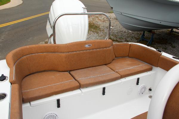 Slide: The Image of 2024 Sea Hunt Ultra 234 boat with brown cushioned seating and white exterior. - 18