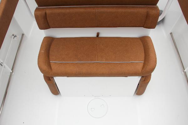 Slide: The Image of 2024 Sea Hunt Ultra 234 boat seating with brown cushions. - 20