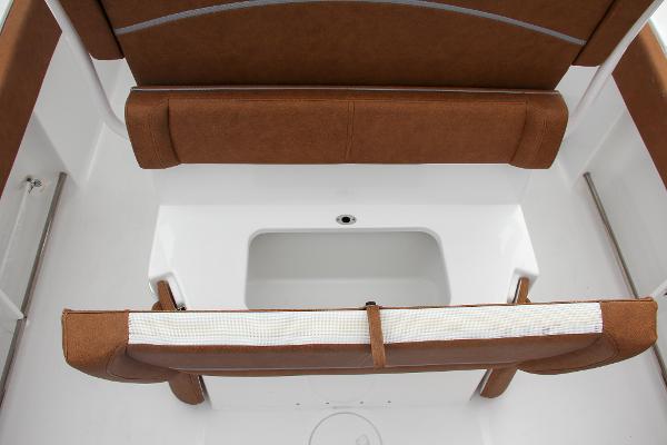 Slide: The Image of 2024 Sea Hunt Ultra 234 boat seating and storage compartment. - 21