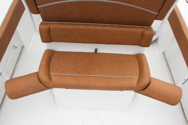 Slide: The Image of 2024 Sea Hunt Ultra 234 boat seating with brown upholstery. - 23
