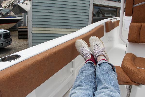 Slide: The Image of Relaxing on a 2024 Sea Hunt Ultra 234 boat with feet up. - 24