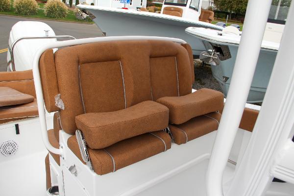 Slide: The Image of 2024 Sea Hunt Ultra 234 boat with brown cushioned seating. - 28