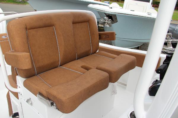 Slide: The Image of 2024 Sea Hunt Ultra 234 boat with brown cushioned seating. - 29