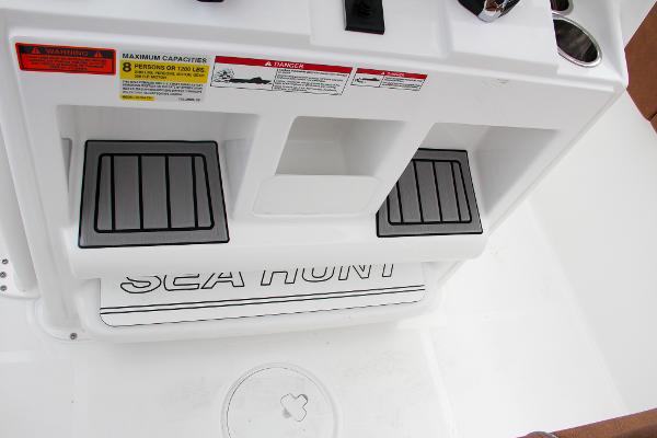 Slide: The Image of 2024 Sea Hunt Ultra 234 boat interior with footrests and safety labels. - 32