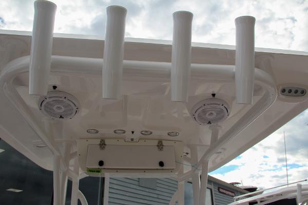 Slide: The Image of 2024 Sea Hunt Ultra 234 boat with rod holders and speakers on the T-top. - 34