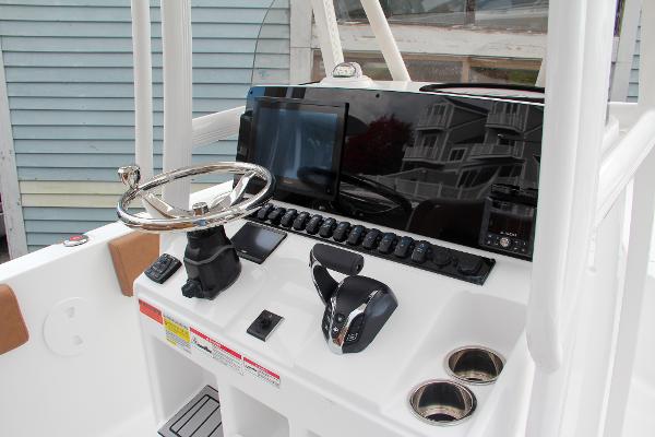 Slide: The Image of 2024 Sea Hunt Ultra 234 boat console with steering wheel and controls. - 36
