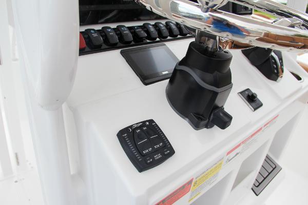 Slide: The Image of Control panel of 2024 Sea Hunt Ultra 234 boat with steering wheel and electronic controls. - 37