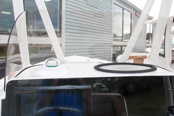 Slide: The Image of 2024 Sea Hunt Ultra 234 boat dashboard with compass and navigation equipment. - 39