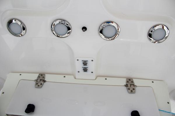 Slide: The Image of 2024 Sea Hunt Ultra 234 boat dashboard with chrome accents and control panel. - 41