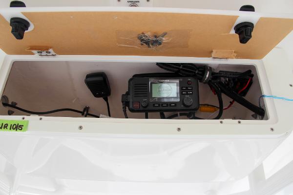 Slide: The Image of Sea Hunt Ultra 234 2024 boat console with marine radio and wiring. - 42