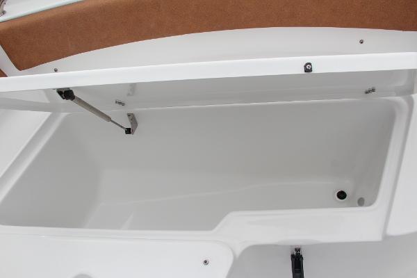 Slide: The Image of 2024 Sea Hunt Ultra 234 storage compartment with open lid. - 46