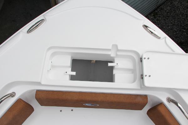 Slide: The Image of 2024 Sea Hunt Ultra 234 bow storage compartment with cushioned seating. - 49