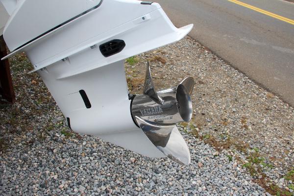 Slide: The Image of Close-up of 2024 Sea Hunt Ultra 234 boat propeller on gravel. - 7