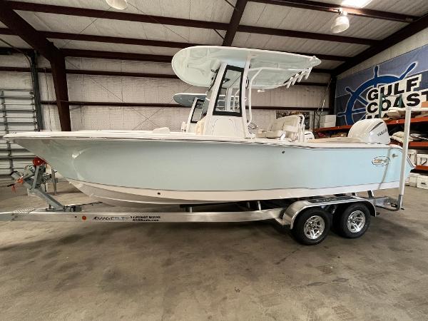Slide: The Image of 2024 Sea Hunt Ultra 239 SE boat on a trailer in a warehouse. - 0