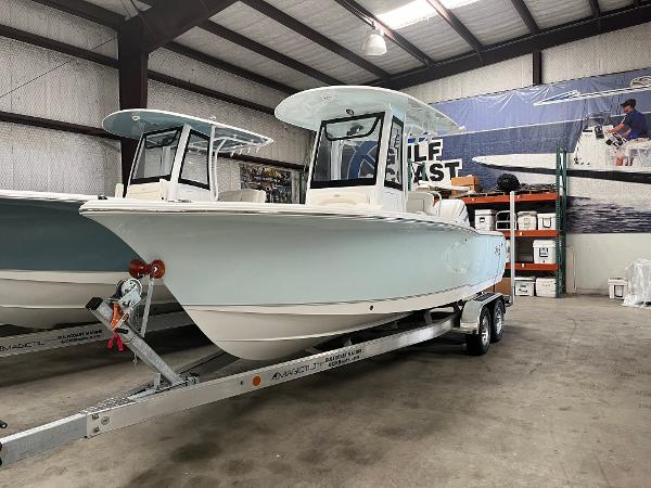 Slide: The Image of 2024 Sea Hunt Ultra 239 SE boat on a trailer in a warehouse. - 1