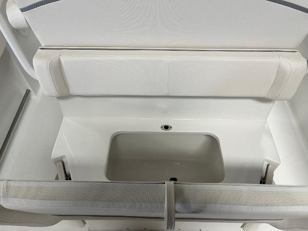 Slide: The Image of 2024 Sea Hunt Ultra 239 SE boat seating and storage compartment. - 17
