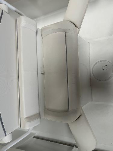 Slide: The Image of 2024 Sea Hunt Ultra 239 SE boat seating area with cushioned seats. - 18