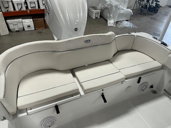 Slide: The Image of 2024 Sea Hunt Ultra 239 SE boat with cushioned seating and storage compartments. - 19