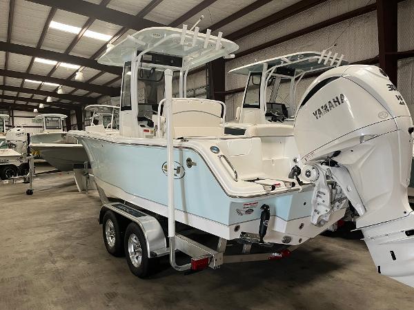 Slide: The Image of 2024 Sea Hunt Ultra 239 SE boat with Yamaha engine in a storage facility. - 2