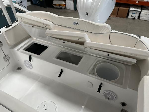 Slide: The Image of 2024 Sea Hunt Ultra 239 SE boat interior with storage compartments and seating. - 20
